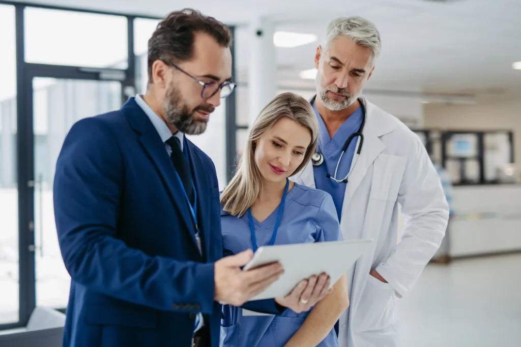 pharmaceutical-sales-representative-talking-with-doctors-in-medical-building-presenting-new-medication-on-t